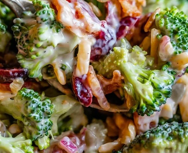 Fresh and colorful broccoli salad with dressing and toppings