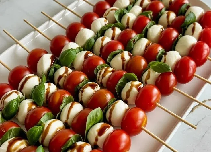 Colorful Caprese Skewers with cherry tomatoes, mozzarella balls, and fresh basil leaves