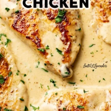Creamy Garlic Parmesan Chicken served with herbs and a side dish