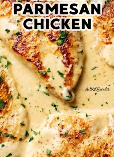 Creamy Garlic Parmesan Chicken served with herbs and a side dish