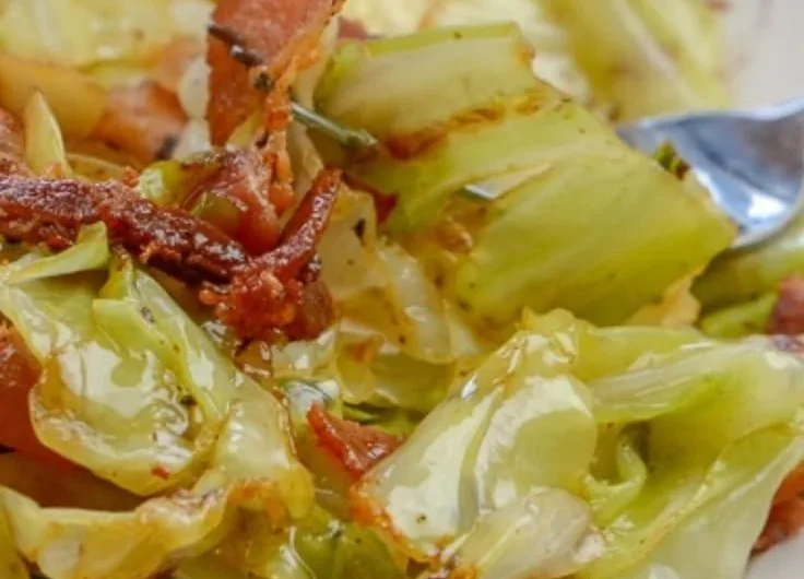 Southern fried cabbage with crispy bacon in a skillet