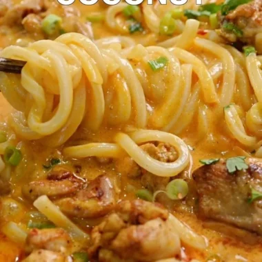 Bowl of Thai-inspired coconut red curry chicken udon with vibrant vegetables