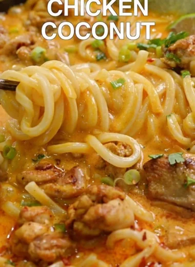 Bowl of Thai-inspired coconut red curry chicken udon with vibrant vegetables