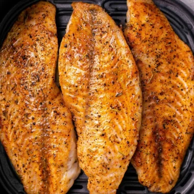 Delicious air-fried tilapia fillets garnished and ready to serve