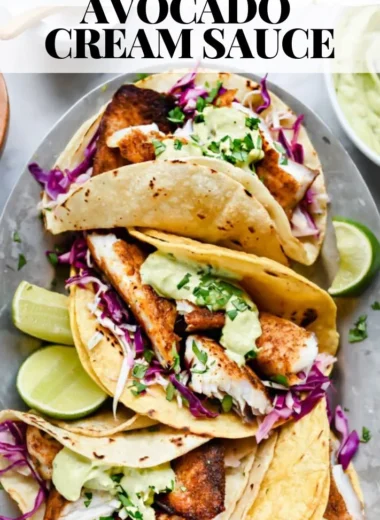 Delicious blackened fish tacos with avocado cream sauce on a plate