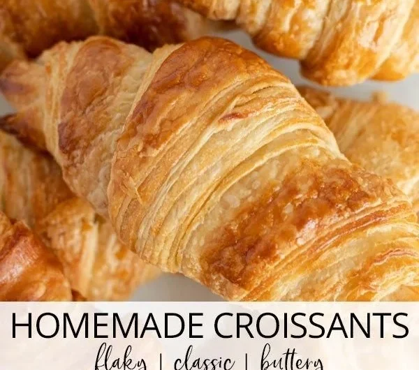 Freshly baked homemade classic croissants on a wooden board