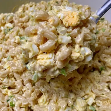 Homemade Mom's macaroni salad in a bowl with fresh vegetables