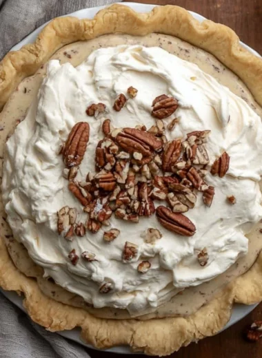 Delicious Pecan Cream Pie served slice on a plate with whipped cream