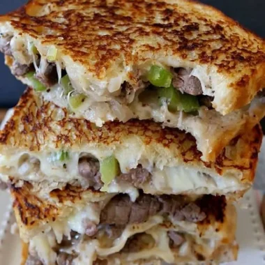 Delicious Philly Cheesesteak Grilled Cheese sandwich on a plate.