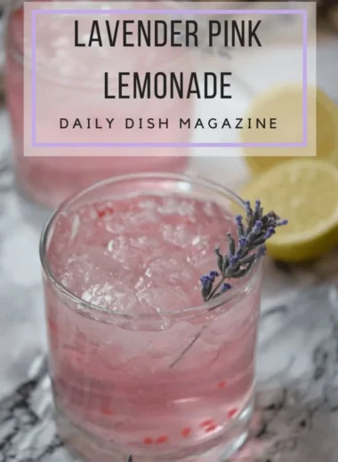 A refreshing glass of pink lavender lemonade garnished with lavender sprigs.