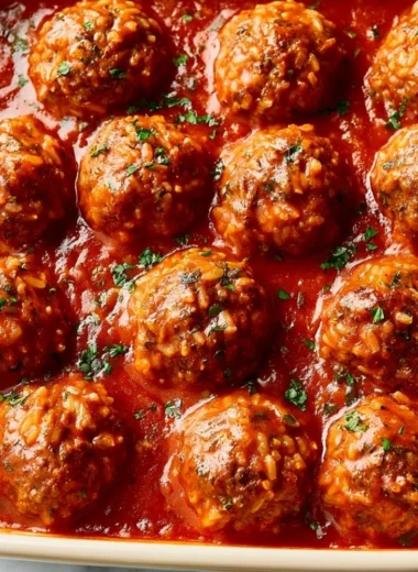 Plate of homemade Porcupine Meatballs with rice and tomato sauce