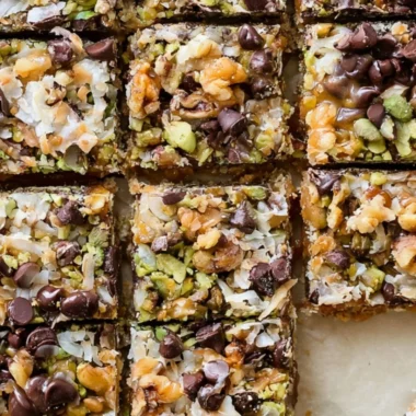 Decadent seven layer bars with chocolate, coconut, and nuts layered beautifully.
