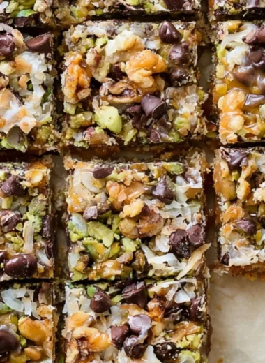 Decadent seven layer bars with chocolate, coconut, and nuts layered beautifully.