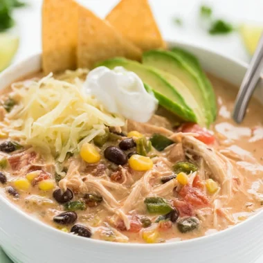 Slow cooker creamy shredded chicken served with Tex Mex flavors