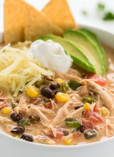 Slow cooker creamy shredded chicken served with Tex Mex flavors
