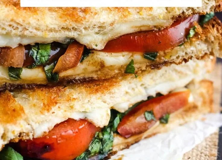 Toasted Caprese sandwich with mozzarella, basil, and tomatoes on crusty bread