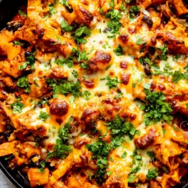 Butternut squash enchilada skillet with black beans and cheese topped