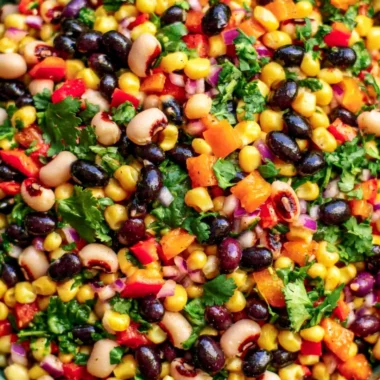 A bowl of cozy cowboy caviar filled with colorful vegetables and beans