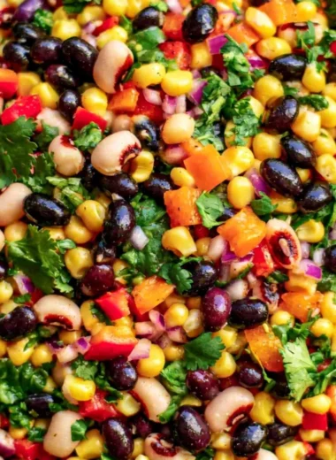 A bowl of cozy cowboy caviar filled with colorful vegetables and beans