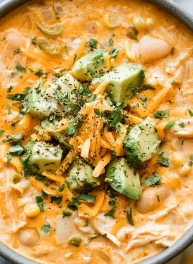 A bowl of creamy white chicken chili topped with cilantro and lime.