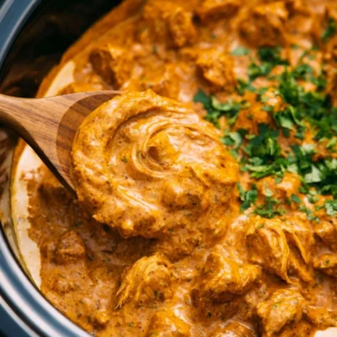 Delicious Cozy Crockpot Butter Chicken served in a bowl with rice
