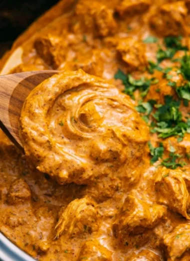 Delicious Cozy Crockpot Butter Chicken served in a bowl with rice