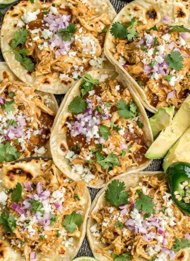 Cozy crockpot chicken tacos served on a plate with fresh toppings