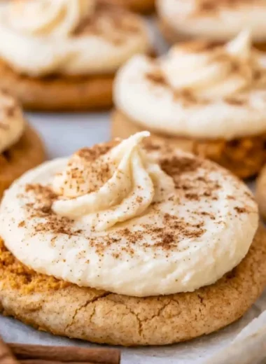 Cozy pumpkin cookies with cream cheese frosting on a rustic plate