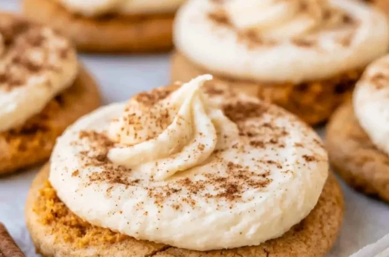 Cozy pumpkin cookies with cream cheese frosting on a rustic plate