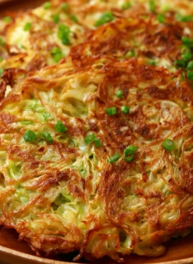 Delicious crispy cabbage pancakes served on a wooden plate.