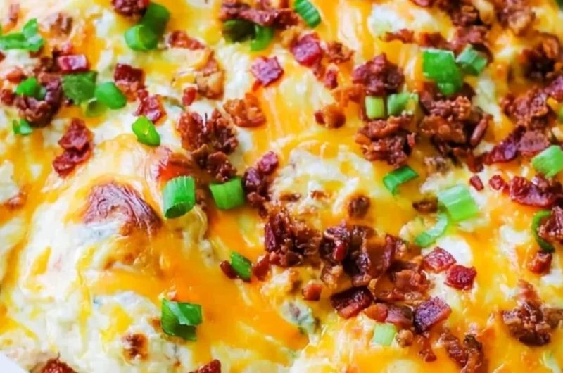 Delicious Million Dollar Chicken Bake topped with cheese and herbs