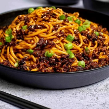 Mongolian Ground Beef Noodles in a bowl, garnished with green onions.
