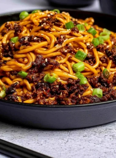 Mongolian Ground Beef Noodles in a bowl, garnished with green onions.
