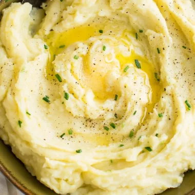 Bowl of perfect creamy mashed potatoes with butter melting on top