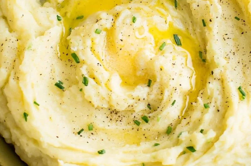 Bowl of perfect creamy mashed potatoes with butter melting on top