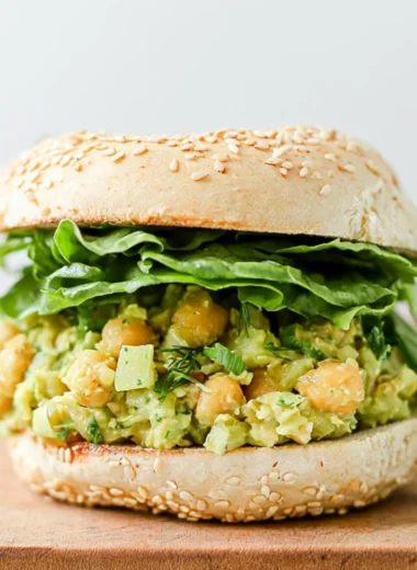 Vegan Chickpea Avocado Sandwich on whole grain bread topped with fresh ingredients.