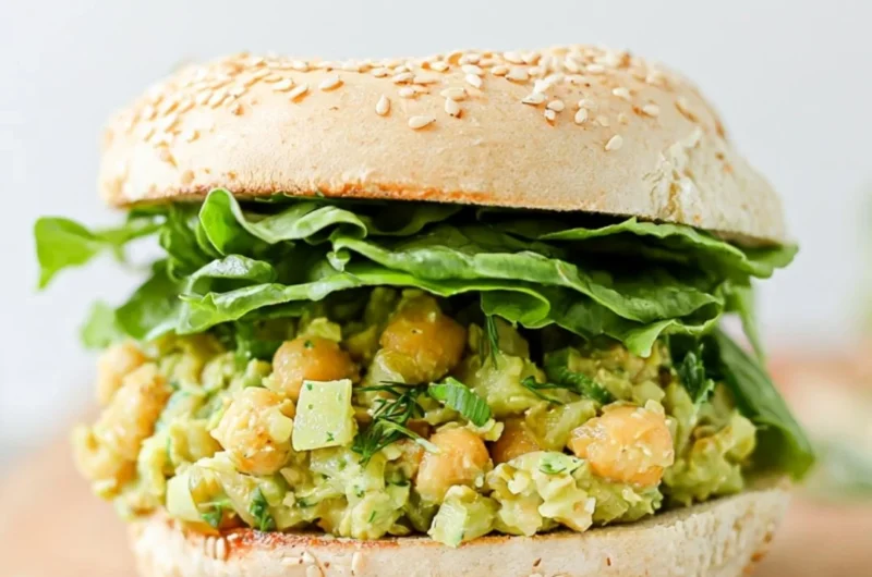 Vegan Chickpea Avocado Sandwich on whole grain bread topped with fresh ingredients.