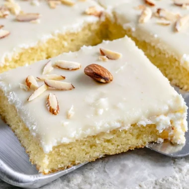 White Texas Almond Sheet Cake served with sliced almonds and frosting
