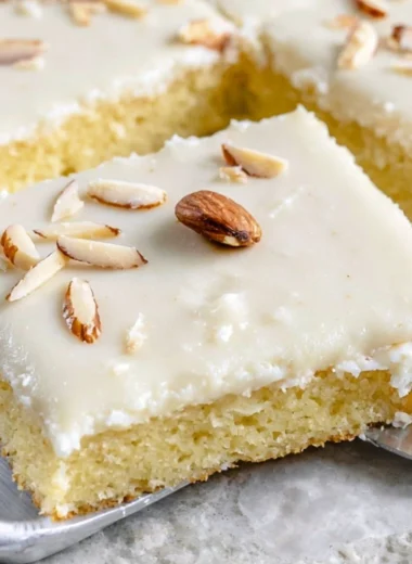 White Texas Almond Sheet Cake served with sliced almonds and frosting