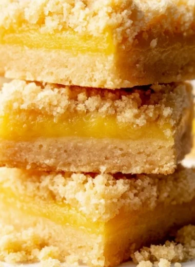 Cozy lemon curd bars topped with powdered sugar, showcasing a sunny dessert treat.