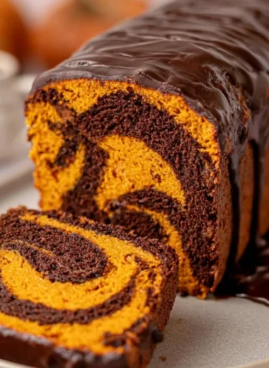 Deliciously cozy vegan pumpkin marble cake on a rustic table.