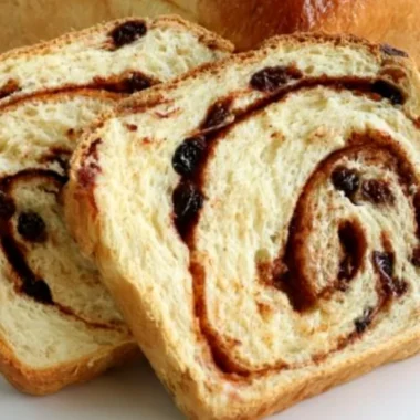 Freshly baked homemade cinnamon swirl raisin bread with swirls of cinnamon and raisins